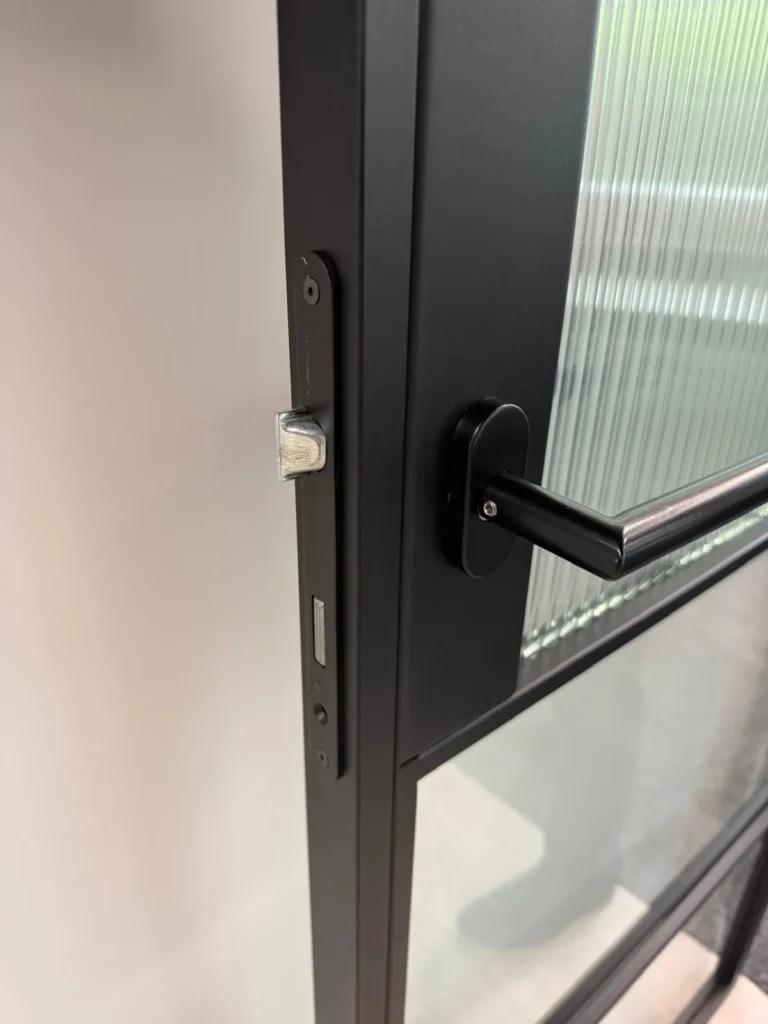 black lever handle and standard lock system on premium frames steel door close up UK
