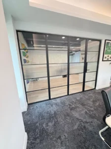 black premium frames steel partition with single hinged door and privacy film office meeting room