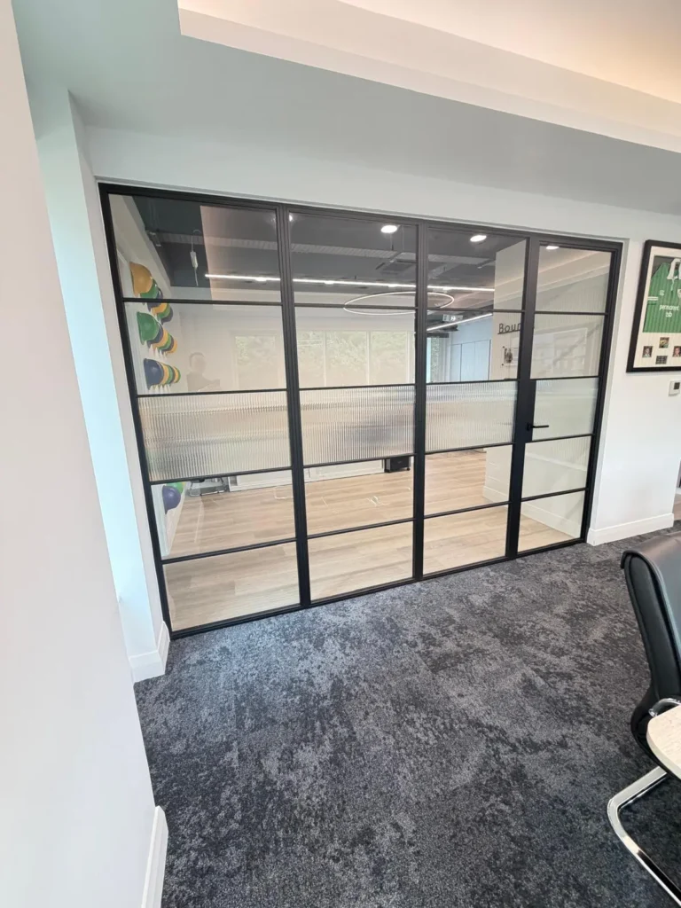 black premium frames steel partition with single hinged door and privacy film office meeting room