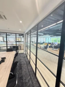 black premium frames steel office partition wall with privacy film running along open plan workspace UK